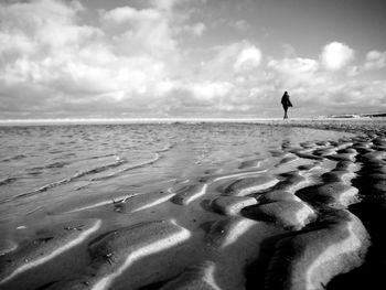 People on beach against sky