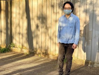 Portrait of young man wearing sunglasses standing outdoors