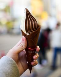 Close-up of hand holding ice cream cone