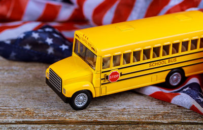 High angle view of figurine school bus on american flag