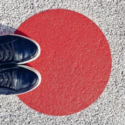 Low section of man standing on tiled floor