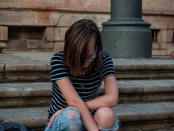 Teenage girl sitting on steps