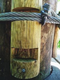 Close-up of rope tied on wood