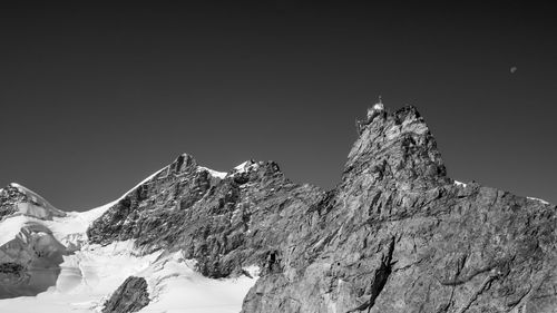 Low angle view of snowcapped mountain against sky