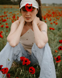 Portrait of young woman standing against trees