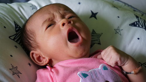 High angle view of cute baby boy sleeping on bed at home
