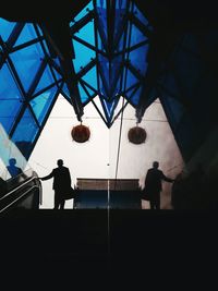 Low angle view of silhouette man standing at home