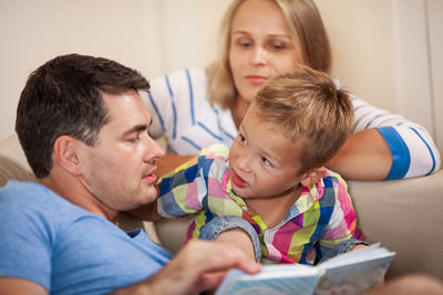 Cute song looking at father by mother in living room