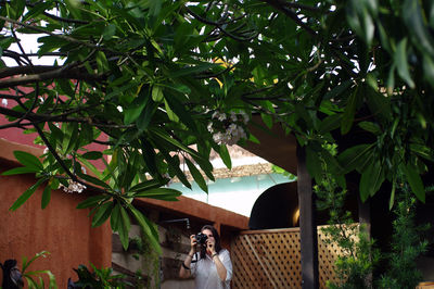 Woman standing by plants