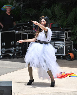 Full length of woman dancing at music concert