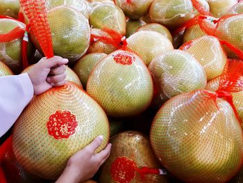 Close-up of hand holding strawberries in market