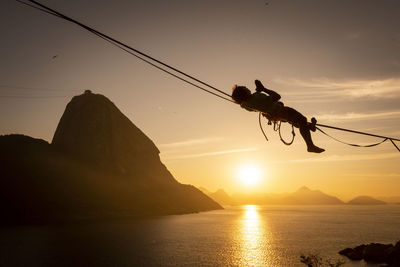 Beautiful sunrise view of man walking on highline with sugar loaf