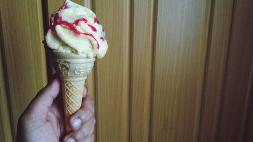 Cropped hand holding ice cream cone