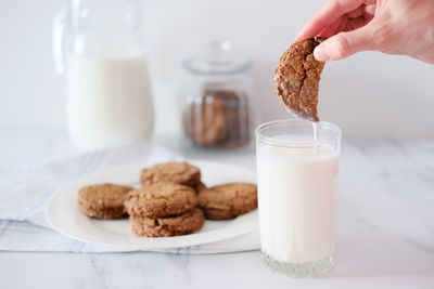 Midsection of woman having breakfast on table