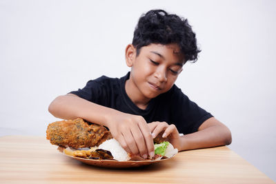 Boy eating food at home