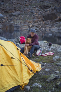 Woman with dog near tent