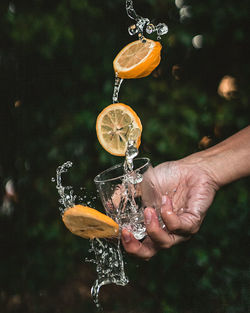 Close-up of hand holding glass of water