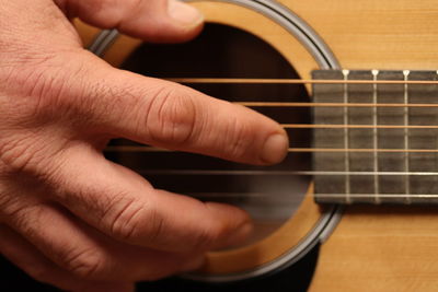 Close-up of hands playing guitar