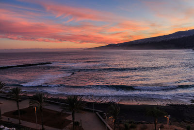 Scenic view of lake against dramatic sky