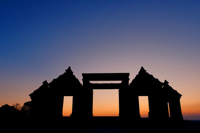 Silhouette historic building against clear sky during sunset