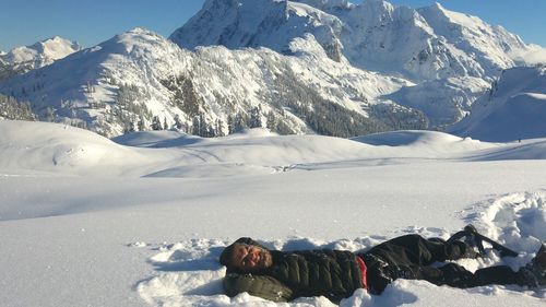 High angle view of person lying in snow