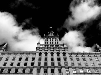 Low angle view of building against cloudy sky