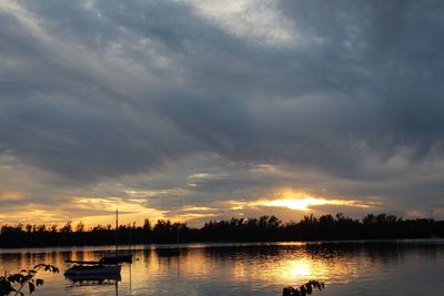 Scenic view of calm lake at sunset