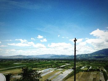 Scenic view of mountains against cloudy sky