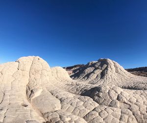 Scenic view of mountains against clear blue sky