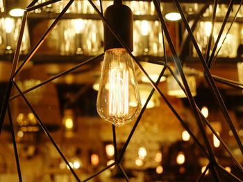 Close-up of illuminated light bulb in lantern at event