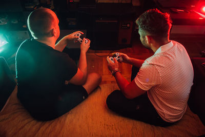 Friends playing video game at home