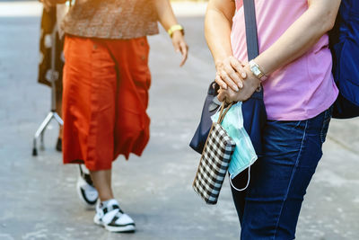 Low section of people walking on street