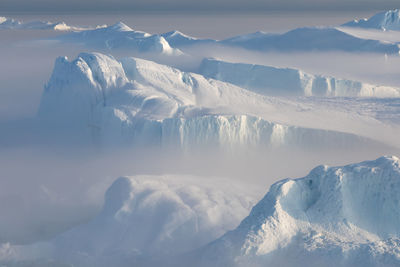 Scenic view of snow covered landscape against sky