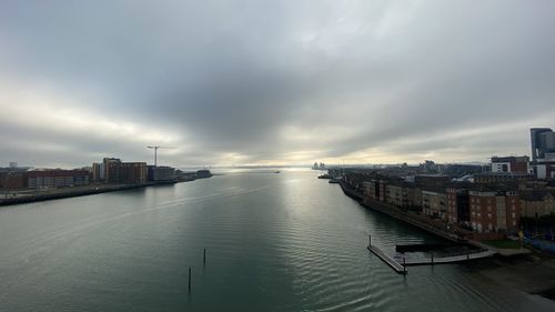 High angle view of sea and buildings against sky