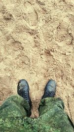 Low section of person standing on tiled floor