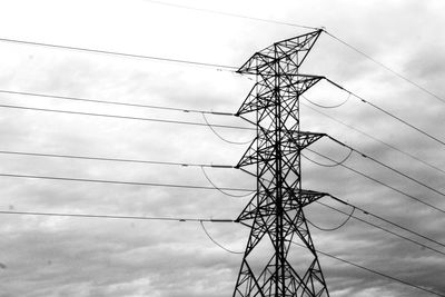 Low angle view of electricity pylon against sky