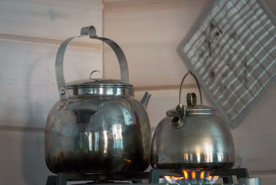 Close-up of kettles on stove at home
