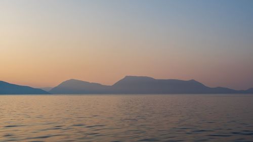 Scenic view of sea against clear sky during sunset