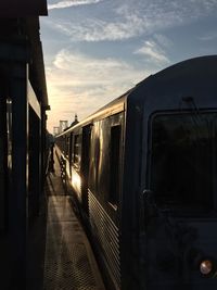 Train at railroad station against sky