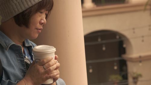 Midsection of woman drinking coffee