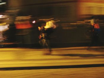 Blurred motion of people at railroad station