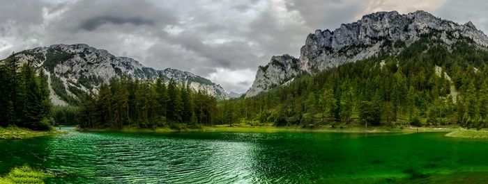 Scenic view of lake and mountains against sky