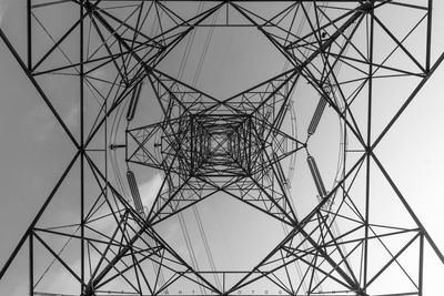 Low angle view of electricity pylon against clear sky
