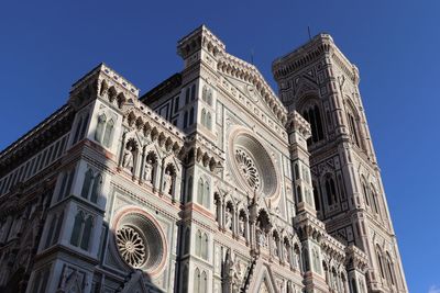 Low angle view of bell tower against blue sky