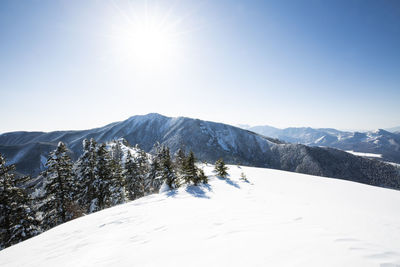 Scenic view of snowcapped mountains against clear sky