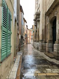 Alley amidst buildings in city