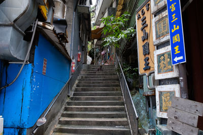 Low angle view of people on staircase in city