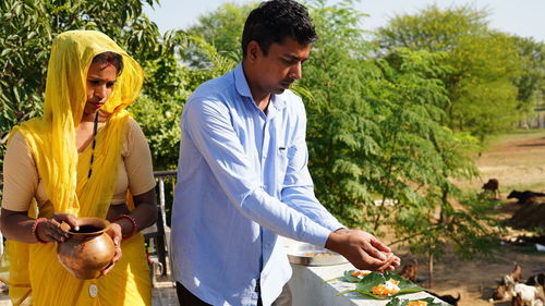 Indian religious family placed food on a leaf for the crow bird to eat. food placed on a green leaf 