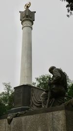 Low angle view of statue against sky