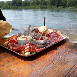 High angle view of breakfast served on jetty against lake